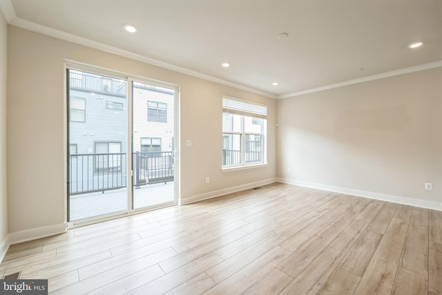 spare room with light hardwood / wood-style flooring and crown molding