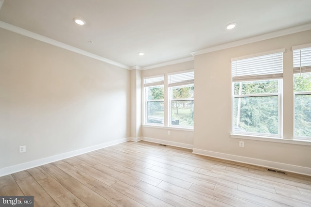 spare room with crown molding and light hardwood / wood-style floors