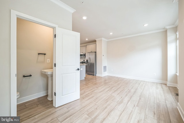 interior space featuring ornamental molding, wood-type flooring, and toilet