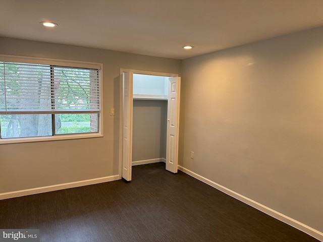 unfurnished bedroom featuring dark wood-type flooring