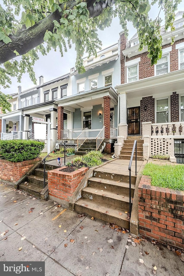 townhome / multi-family property with covered porch