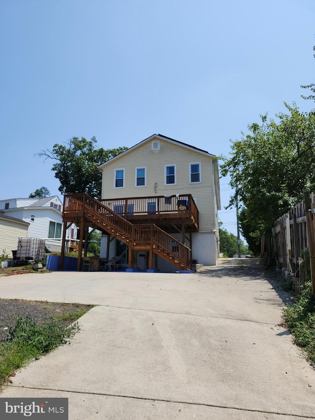 rear view of house featuring a deck