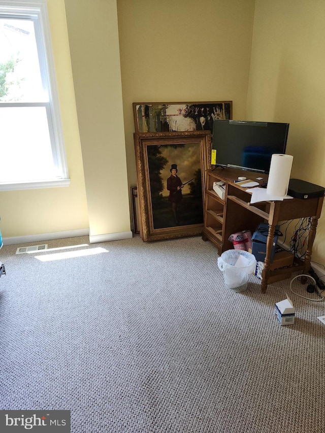 home office featuring a wealth of natural light and carpet flooring