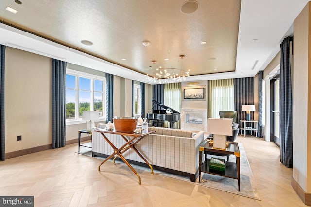 living room featuring light parquet floors, a tray ceiling, and a chandelier