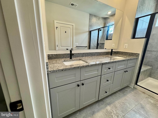 bathroom featuring vanity, tile patterned floors, and a shower with door