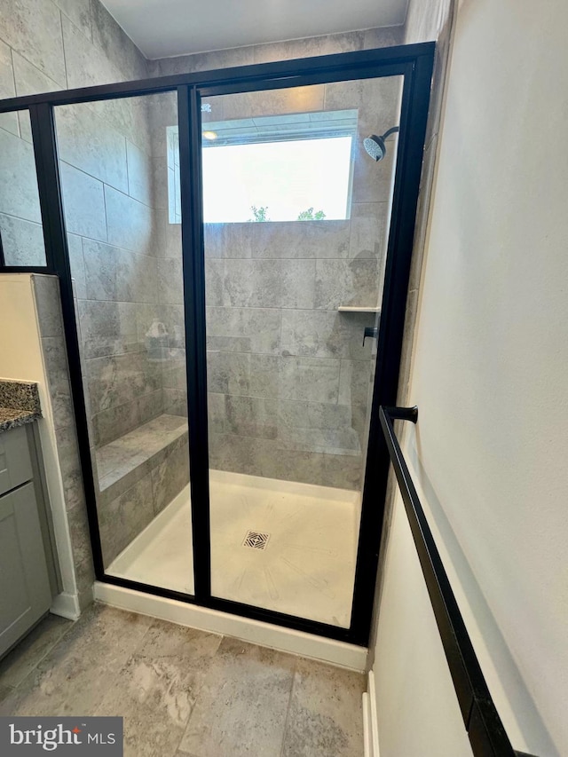 interior space with vanity and a shower with door