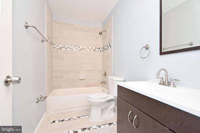 full bathroom featuring tile patterned floors, vanity, tiled shower / bath combo, and toilet