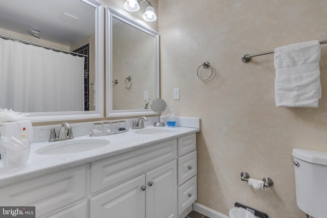 bathroom featuring vanity, a shower with shower curtain, and toilet