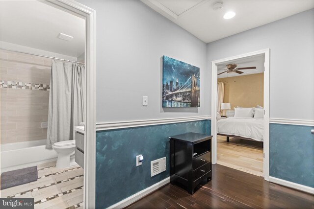 bedroom with dark hardwood / wood-style flooring and ceiling fan