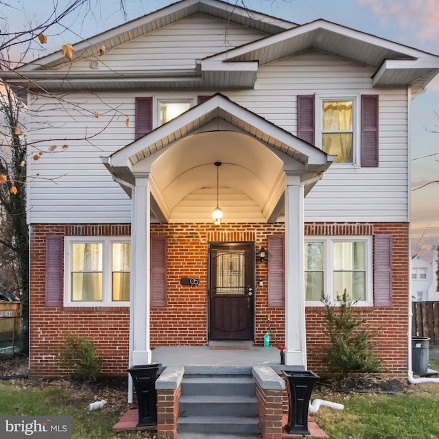 exterior entry at dusk with a porch