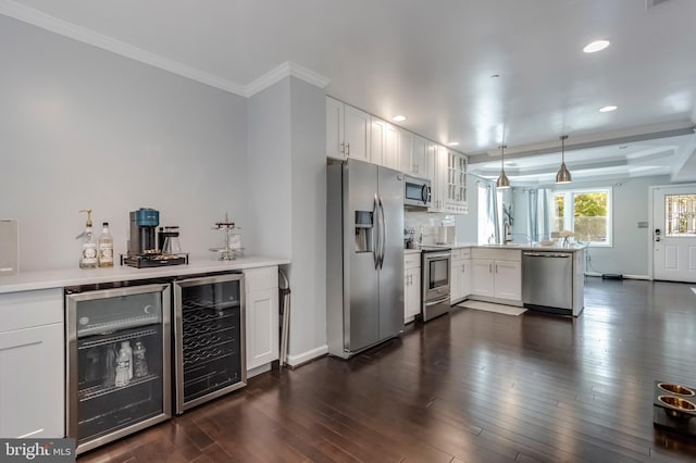 kitchen with kitchen peninsula, white cabinetry, beverage cooler, and appliances with stainless steel finishes