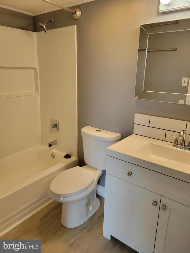 full bathroom featuring  shower combination, hardwood / wood-style flooring, vanity, and toilet