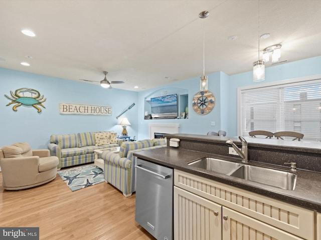 kitchen with hanging light fixtures, light hardwood / wood-style flooring, ceiling fan, stainless steel dishwasher, and sink