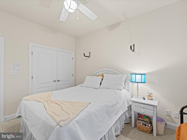 carpeted bedroom with ceiling fan and a closet