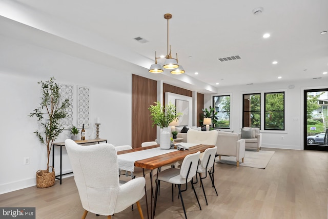 dining room with a notable chandelier and light hardwood / wood-style floors