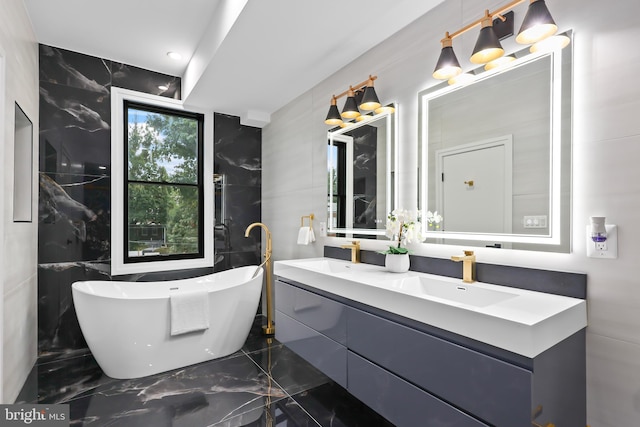 bathroom with tile walls, vanity, and a bathing tub