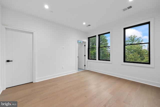 unfurnished room with light hardwood / wood-style flooring