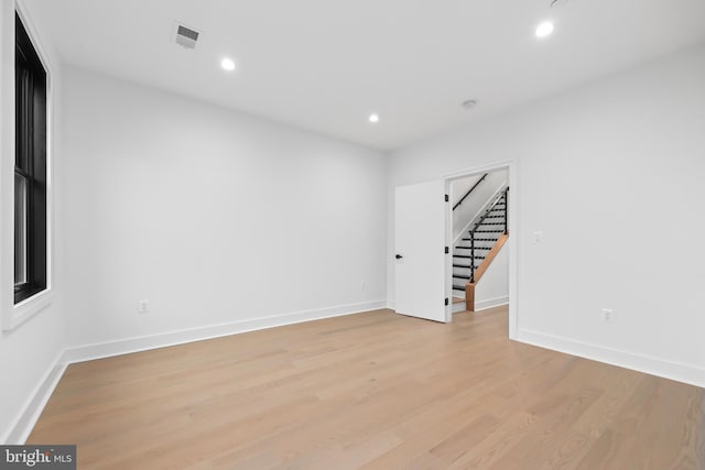 spare room with light hardwood / wood-style flooring