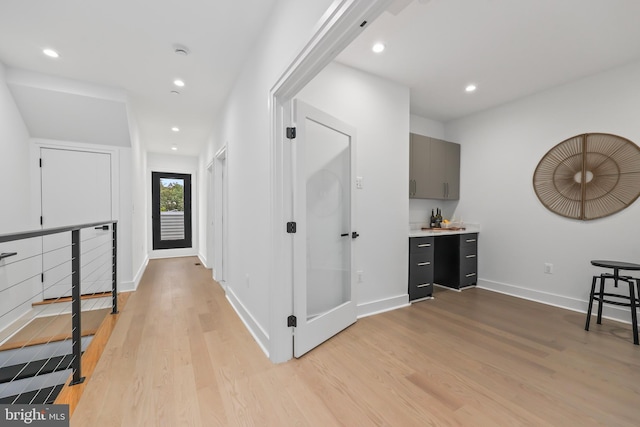 hallway with light hardwood / wood-style floors