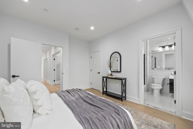 bedroom featuring light wood-type flooring and ensuite bathroom