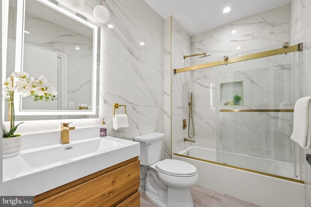 full bathroom featuring enclosed tub / shower combo, vanity, tile walls, and toilet