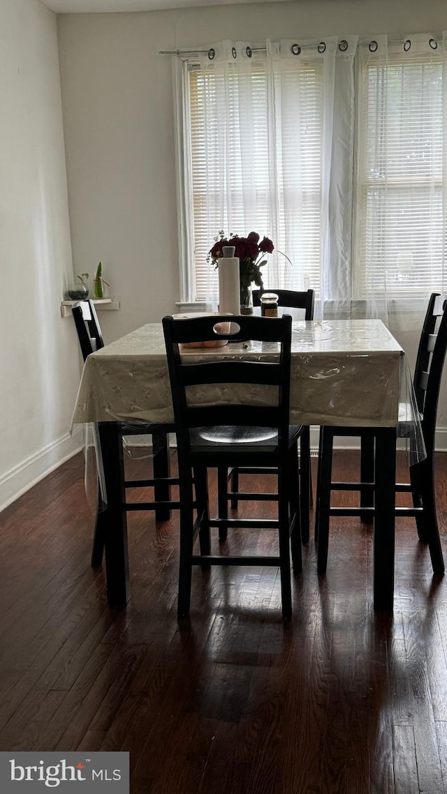 dining area with dark hardwood / wood-style flooring