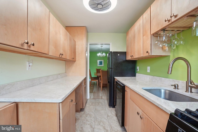 kitchen with light stone counters, sink, a chandelier, light brown cabinetry, and black dishwasher