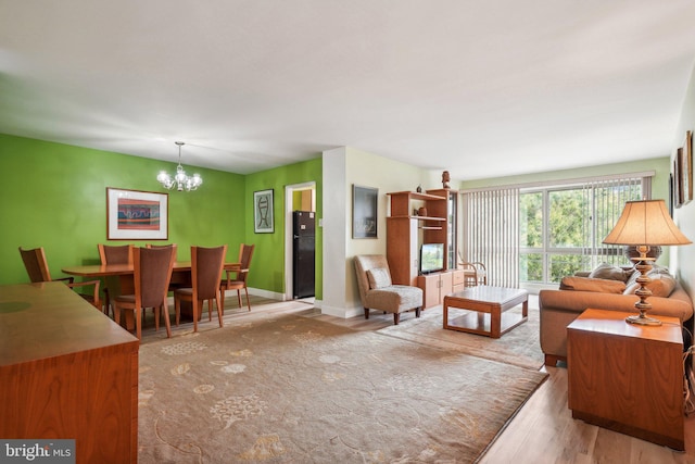 living room with a notable chandelier and light wood-type flooring