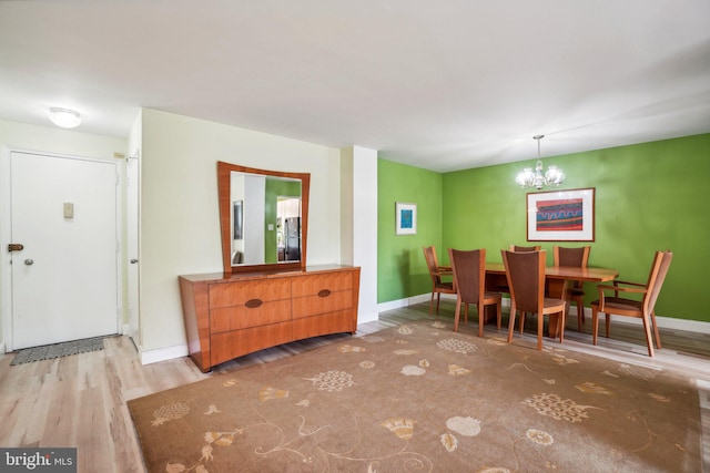 dining area featuring a chandelier and light hardwood / wood-style floors