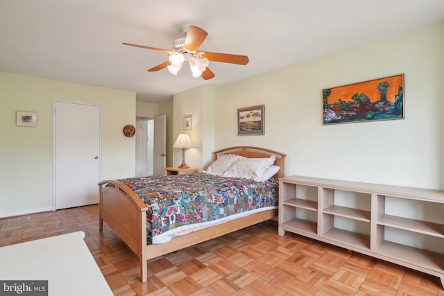 bedroom featuring ceiling fan and light parquet floors