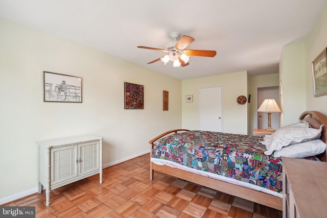 bedroom with light parquet flooring and ceiling fan