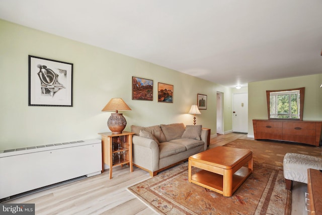 living room featuring radiator and light hardwood / wood-style floors