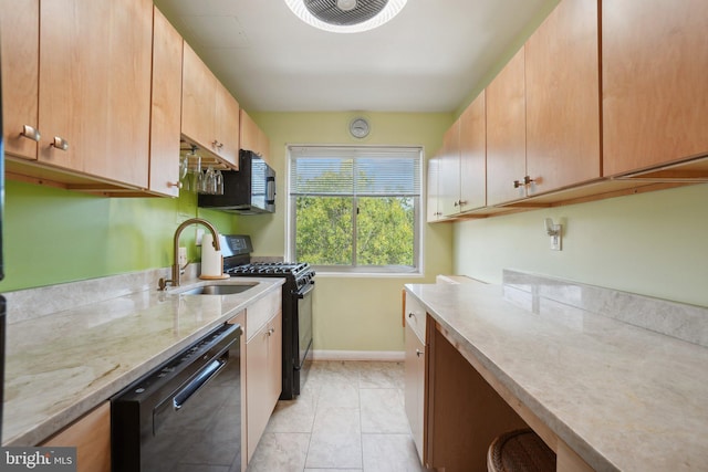 kitchen featuring black appliances, light tile patterned floors, and sink