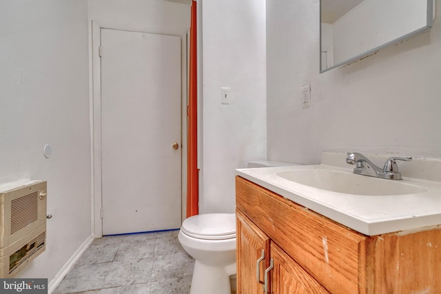 bathroom featuring vanity, heating unit, toilet, and tile patterned floors