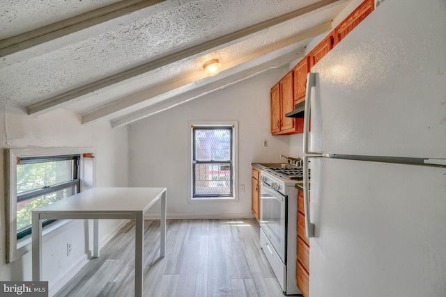 kitchen featuring vaulted ceiling with beams, light wood-type flooring, and white appliances