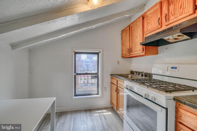 kitchen featuring vaulted ceiling with beams, sink, a textured ceiling, light hardwood / wood-style flooring, and white range with gas cooktop