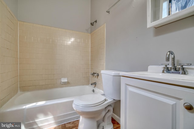 full bathroom featuring tiled shower / bath combo, vanity, and toilet