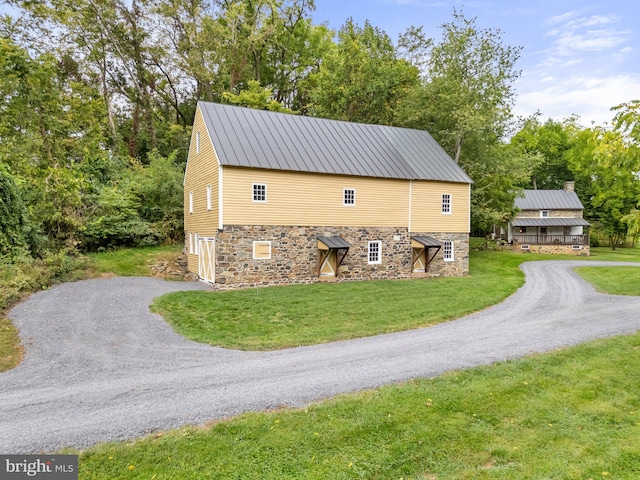 view of side of property with a lawn