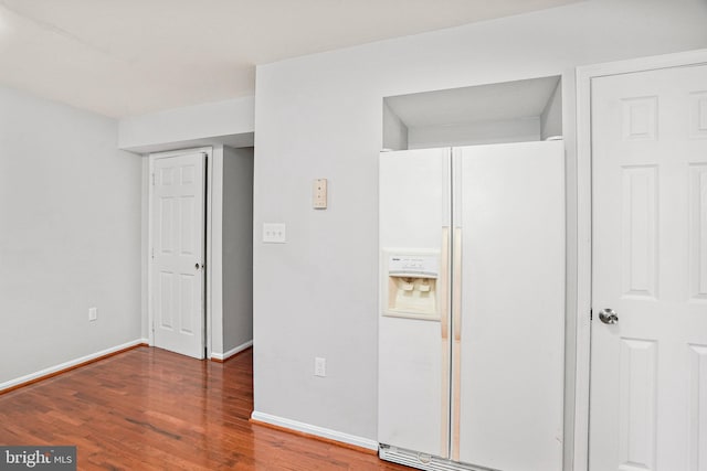 kitchen with white fridge with ice dispenser and hardwood / wood-style floors