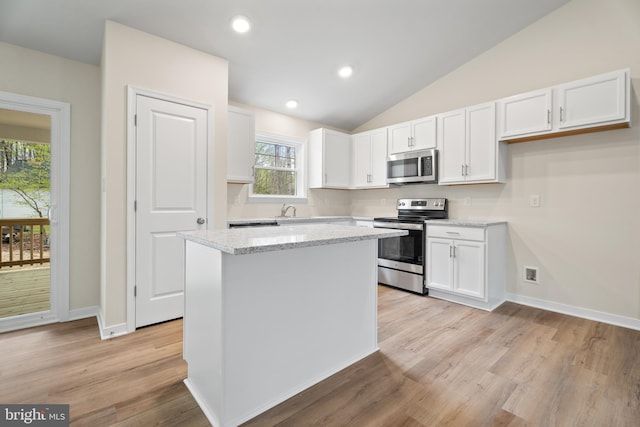 kitchen with a center island, white cabinetry, light wood-type flooring, and stainless steel appliances