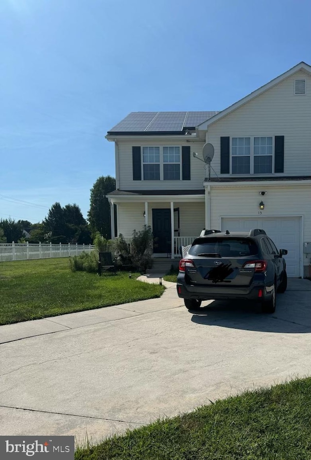 view of front facade featuring a front lawn, solar panels, covered porch, and a garage