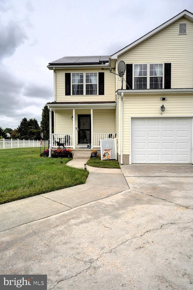 13 Kennison Ln, Dover, DE 19901 - traditional-style house with covered porch, a front lawn, solar panels, an attached garage, and driveway