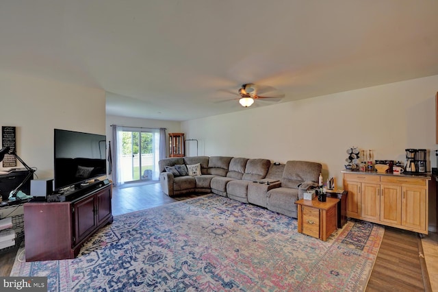 living room featuring hardwood / wood-style floors and ceiling fan