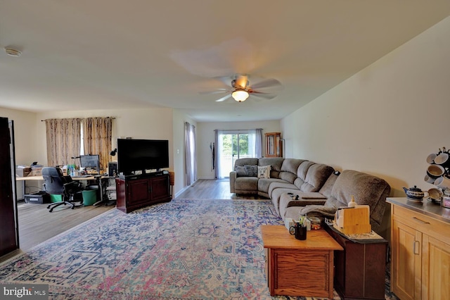 living room with light hardwood / wood-style floors and ceiling fan