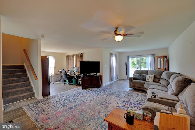 living room featuring ceiling fan and light wood-type flooring