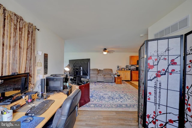 interior space with ceiling fan and light hardwood / wood-style flooring