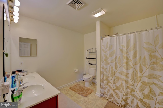 bathroom featuring vanity, toilet, and a shower with curtain