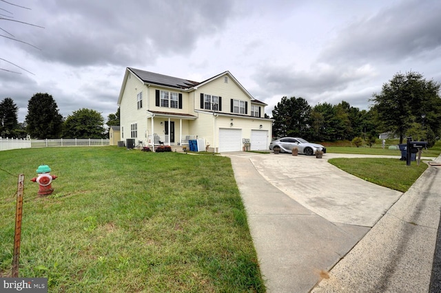 view of front of property with a front yard, a garage, and central AC unit