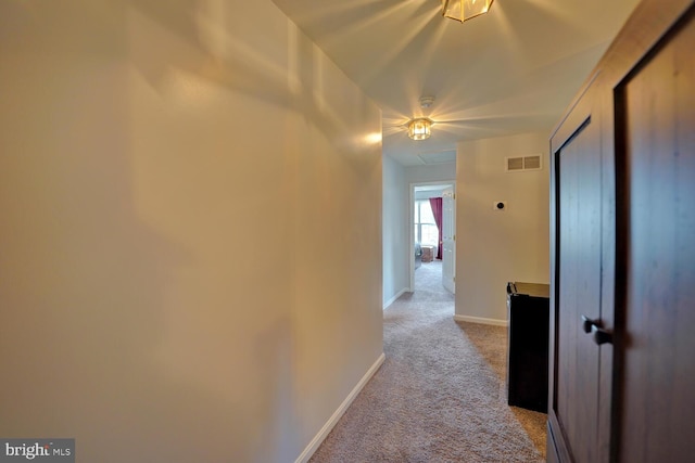 hallway with light colored carpet