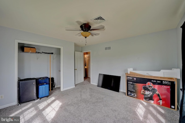 unfurnished bedroom with ceiling fan, light colored carpet, and a closet